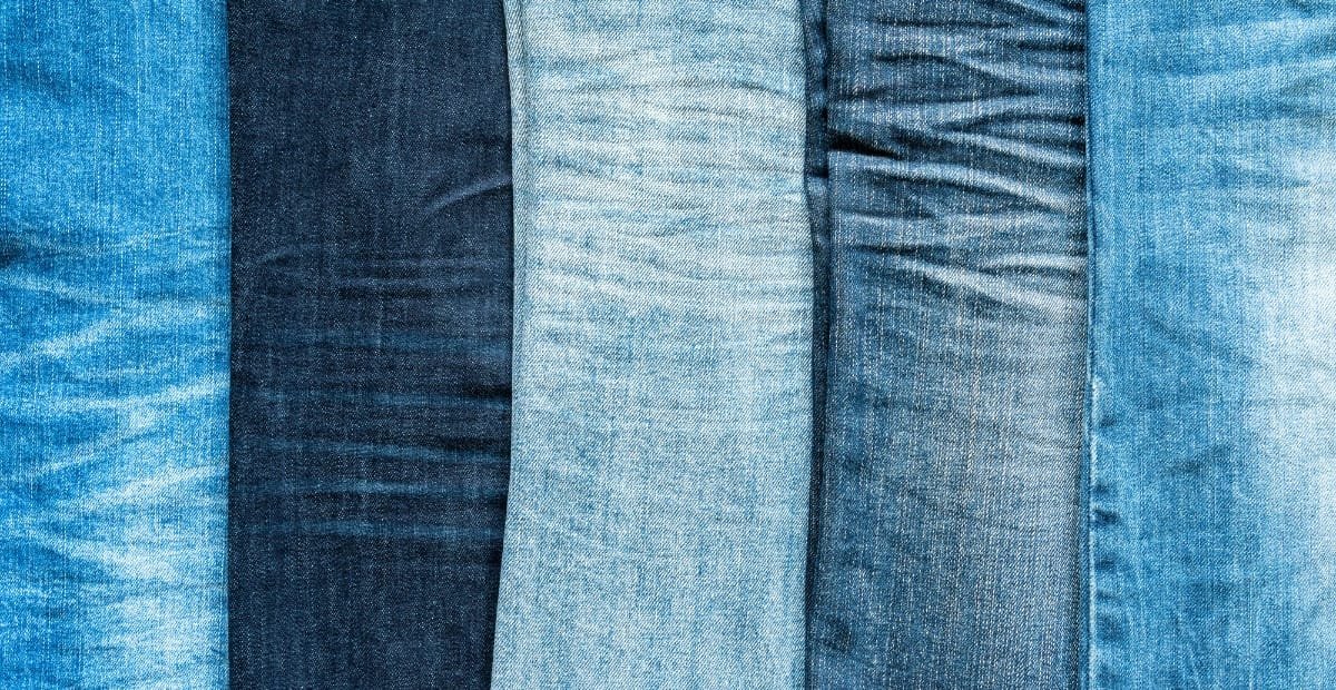 A close-up image displaying five different types of denim fabric, showcasing variations in color and texture.
