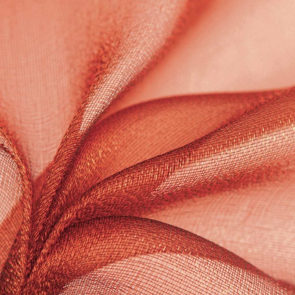Close-up image of delicate, semi-transparent, peach-colored polyester organza fabric with a shimmering, fine mesh texture.