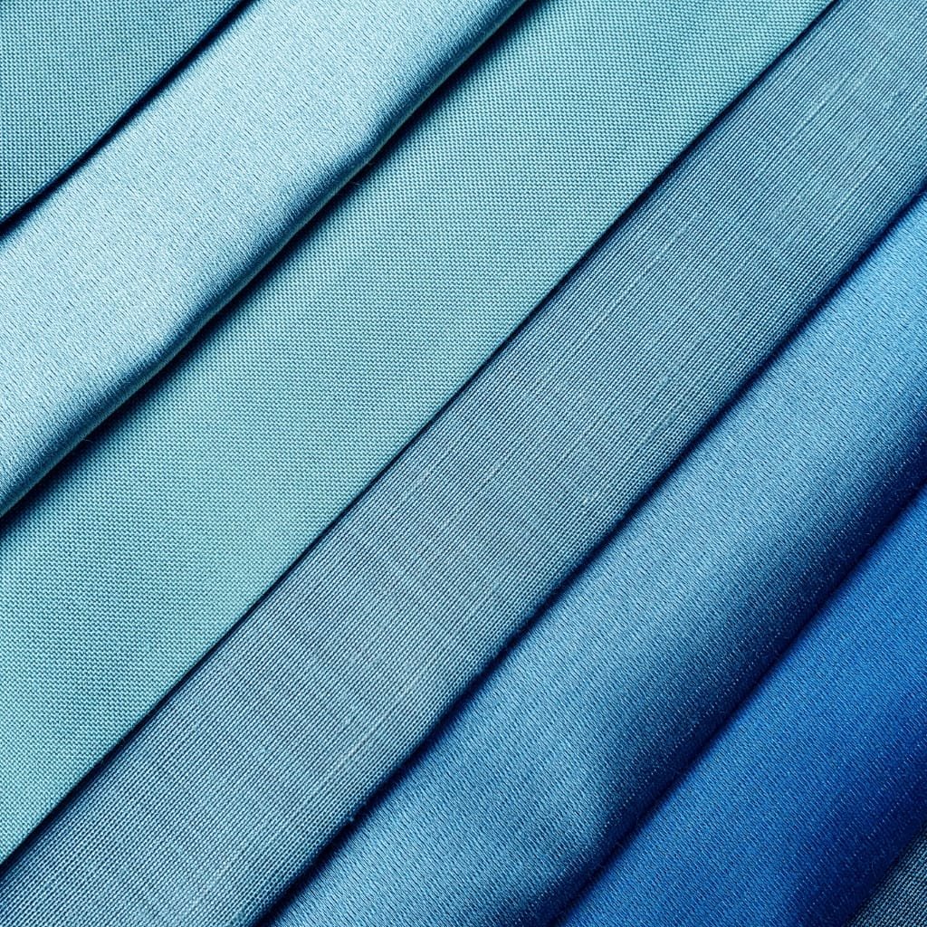 Close-up image of neatly folded, shiny blue nylon organza fabric showcasing its smooth, crisp texture and vibrant color.