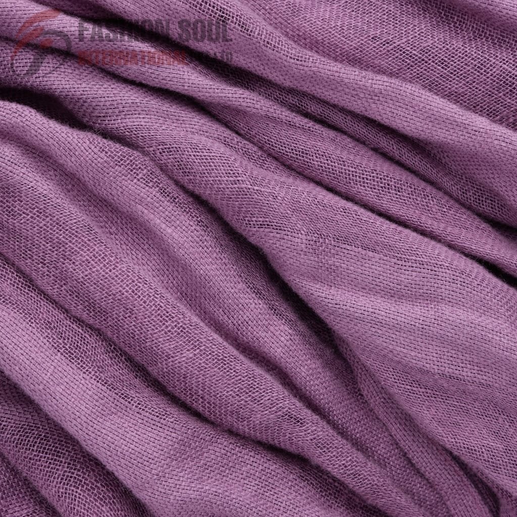 Close-up image of soft purple fabric with a textured, mesh-like pattern and gentle folds.