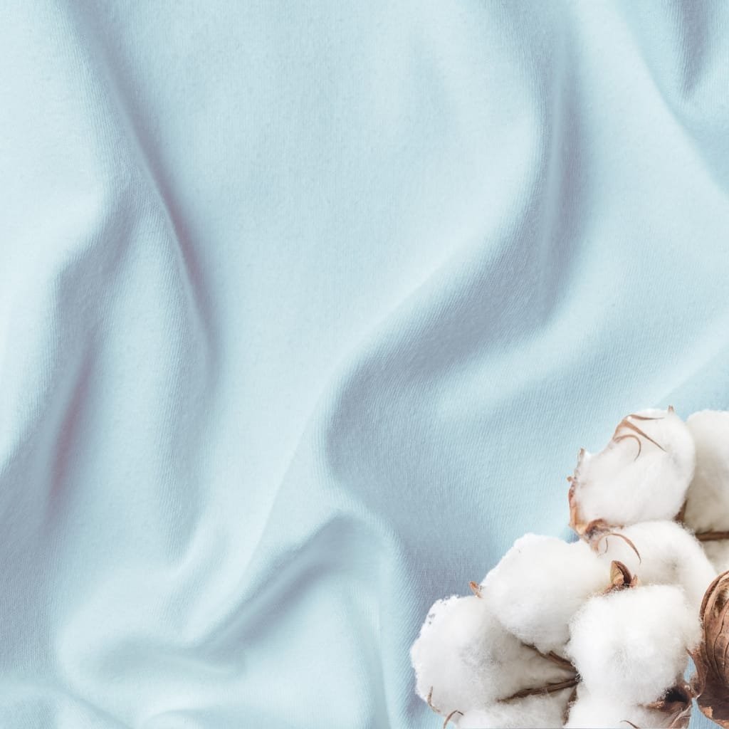 Close-up image of smooth, light blue, and slightly shiny cotton fabric with a cluster of cotton bolls at the bottom right corner.