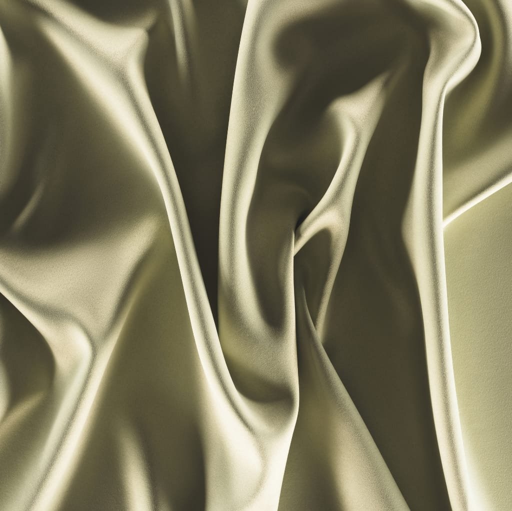 Close-up of a smooth, shiny satin fabric with gentle folds and a lustrous surface, showcasing its luxurious texture and reflective sheen.
