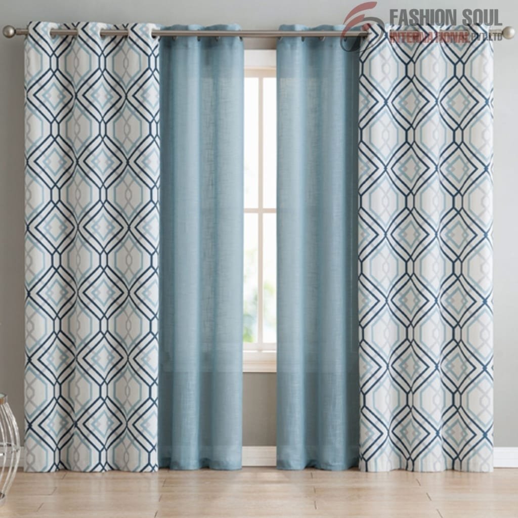 Light blue patterned and solid blue curtains hanging on a window with a simple rod in a bright room.