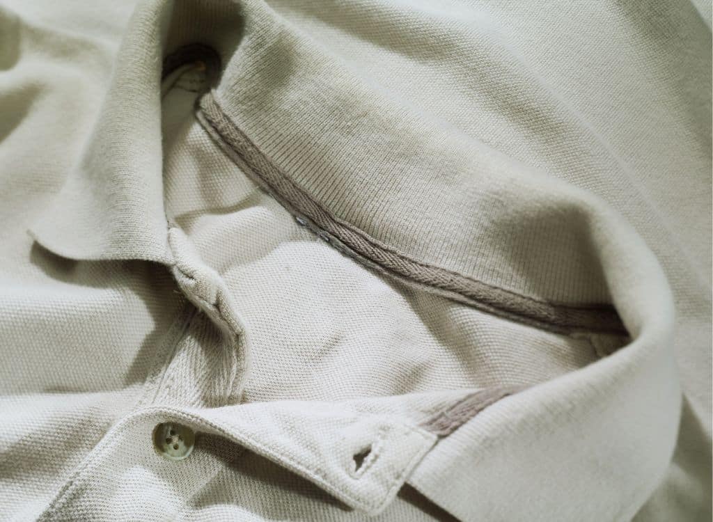 Close-up of the collar and button area of a customized polo shirt, showcasing the fine stitching and fabric details.