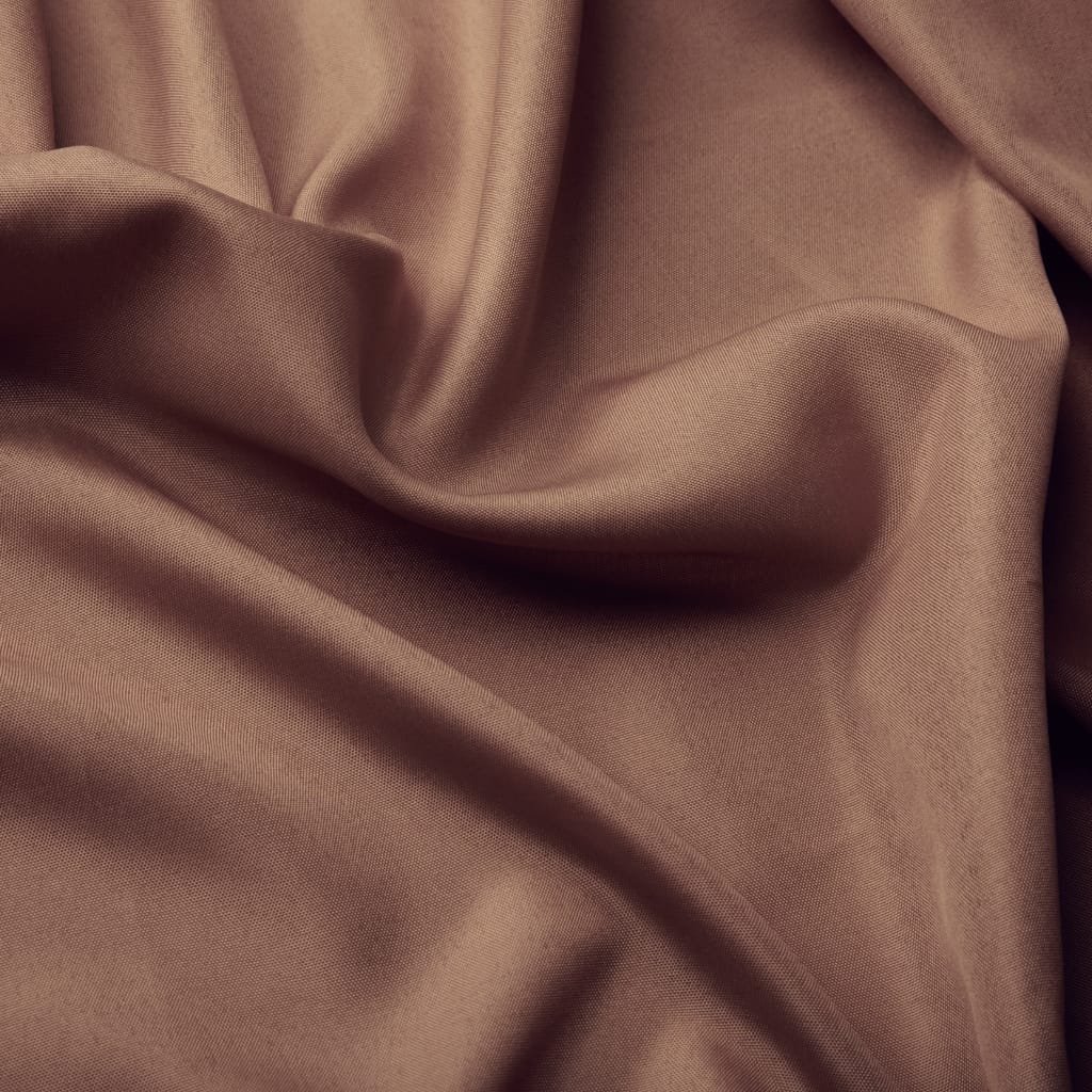 : A close-up of smooth, light brown polyester-spandex fabric with gentle folds and slight sheen.