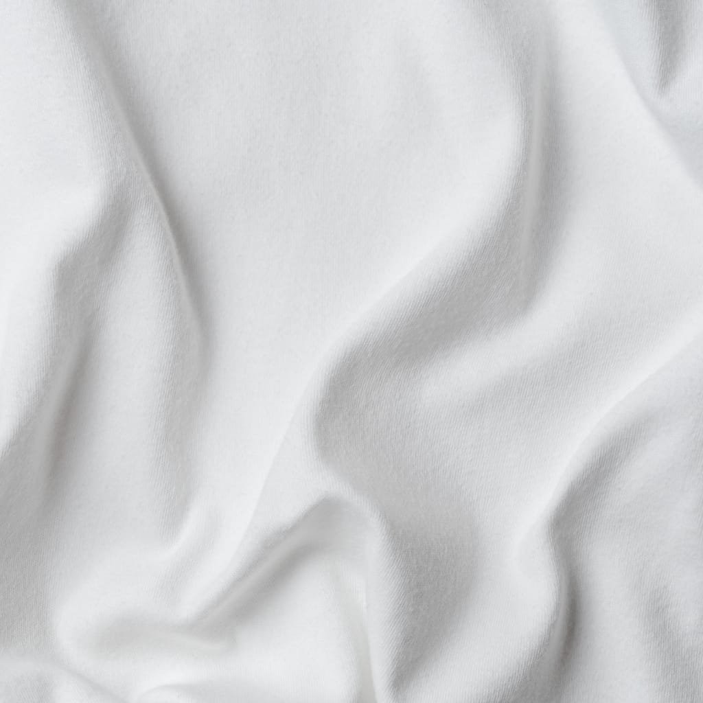 Close-up of smooth, white fabric with gentle folds and a soft sheen, showcasing its delicate texture and light draping.