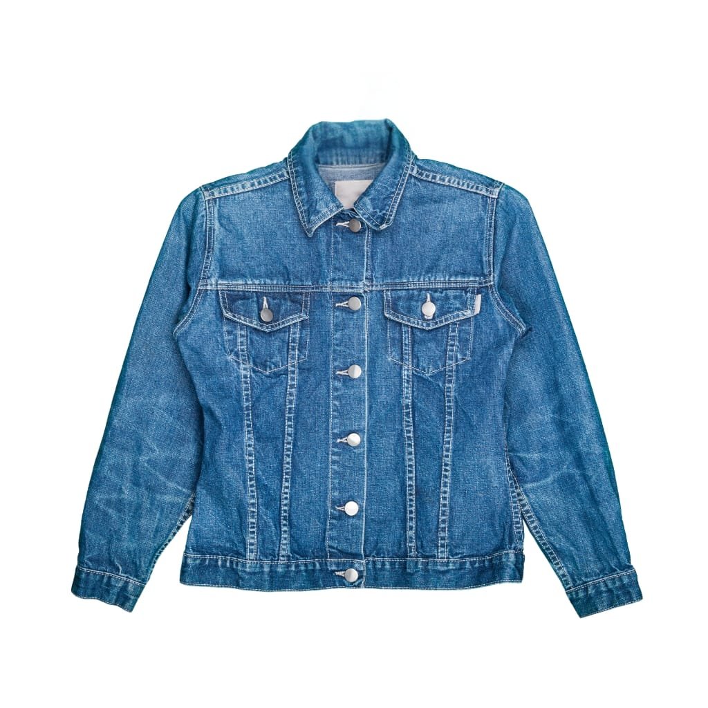 A classic blue chambray denim jacket with front button closure, two chest flap pockets, and buttoned cuffs, shown against a plain white background.