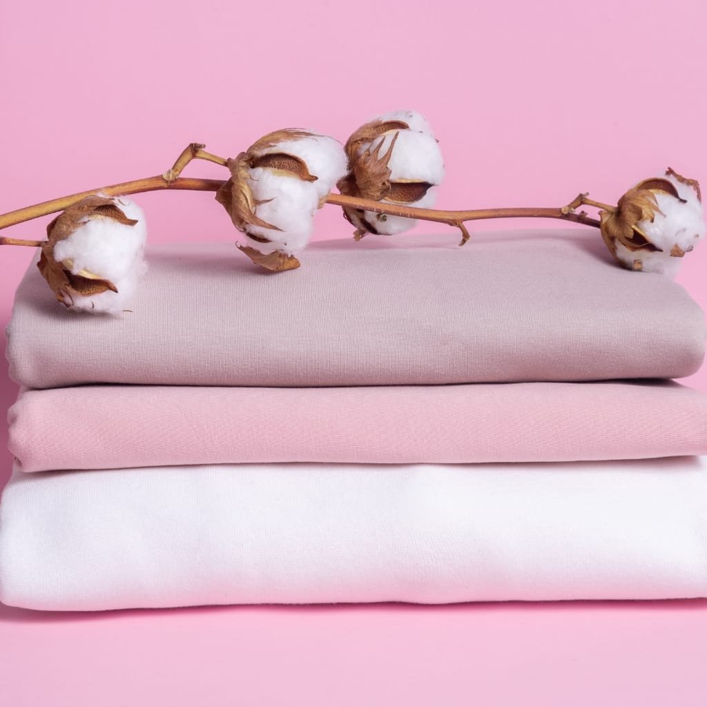 A variety of cotton fabrics showcasing different textures and weaves, emphasizing the importance of selecting the right cotton fabric for clothing.
