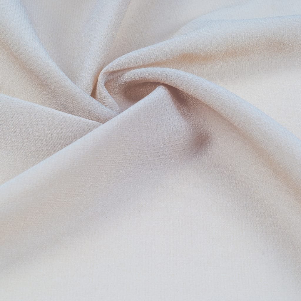 A close-up photograph of smooth, light-colored fabric with gentle folds and a slight sheen, likely showing the texture of spandex fabric.