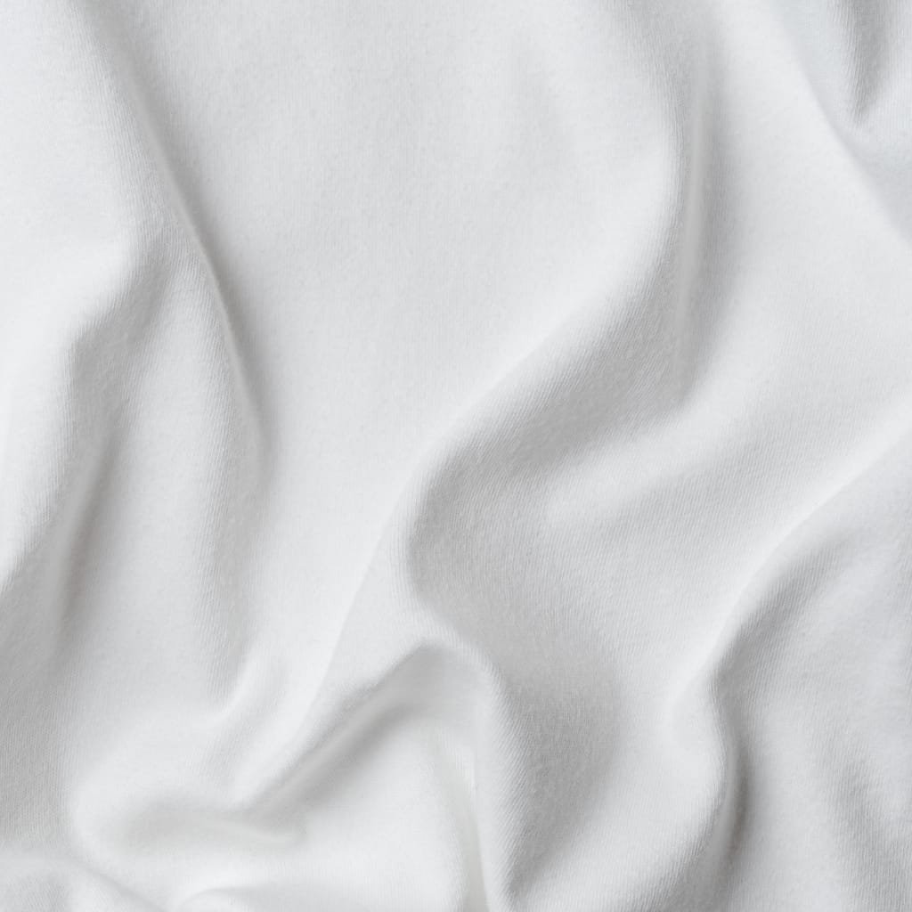 Close-up of smooth, white cupro fabric with gentle folds and a lustrous surface.