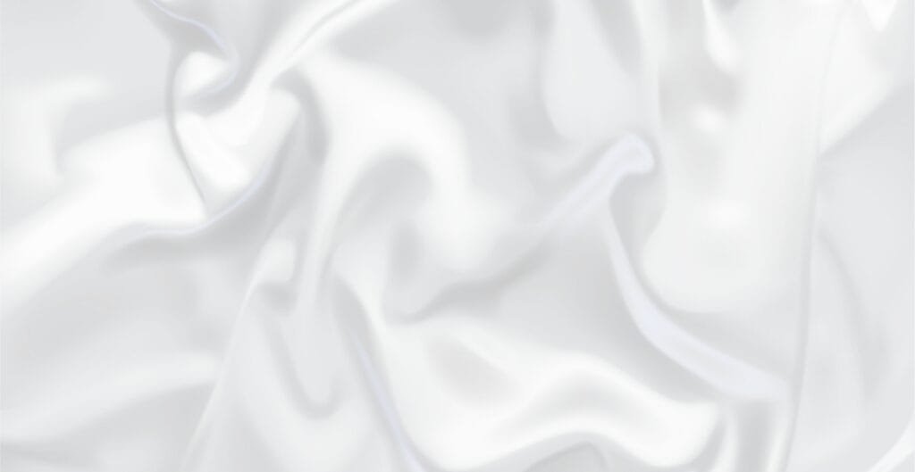 Close-up of a white cupro fabric with soft, flowing, and slightly textured appearance.
