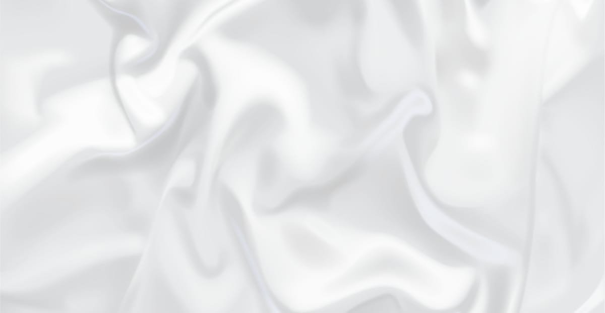 Close-up of a white cupro fabric with soft, flowing, and slightly textured appearance.