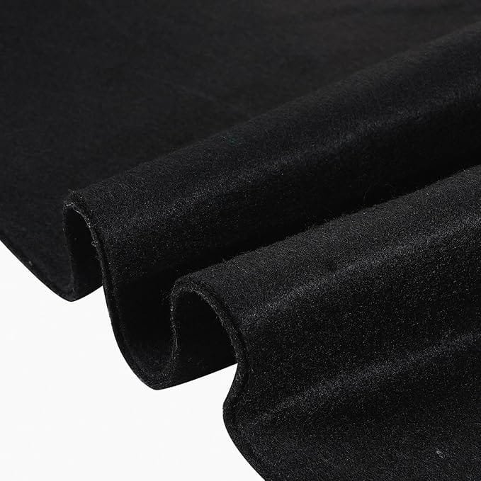 Close-up of folded black velvet fabric with a soft, plush texture.