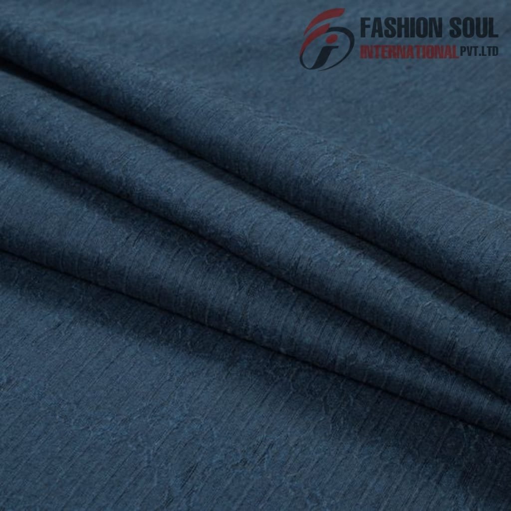  Close-up of folded dark blue denim fabric with a textured surface.