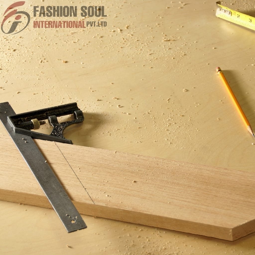 Close-up of a woodworking scene featuring a wooden board, a square, a pencil, and a measuring tape on a work surface.