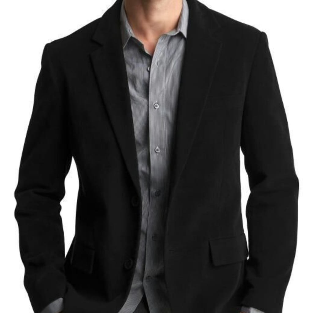 A person wearing a tailored black sport coat over a light grey, pinstriped dress shirt against a white background.