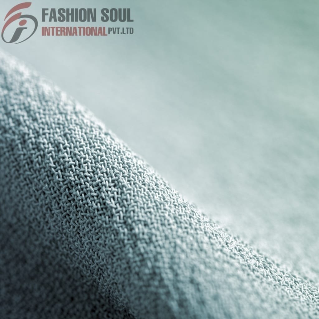 Close-up of smooth, light-colored fabric with a subtle texture and fine weave.