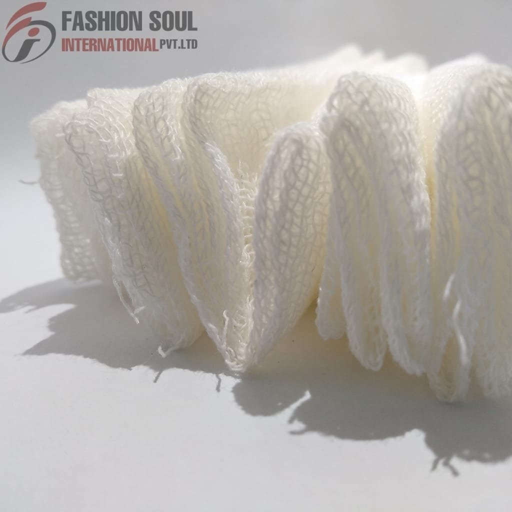 A close-up photograph of white loofah sponges arranged standing upright on a white surface, with shadows cast behind them. In the top left corner, there is a logo and text reading "FASHION SOUL INTERNATIONAL PVT.LTD."