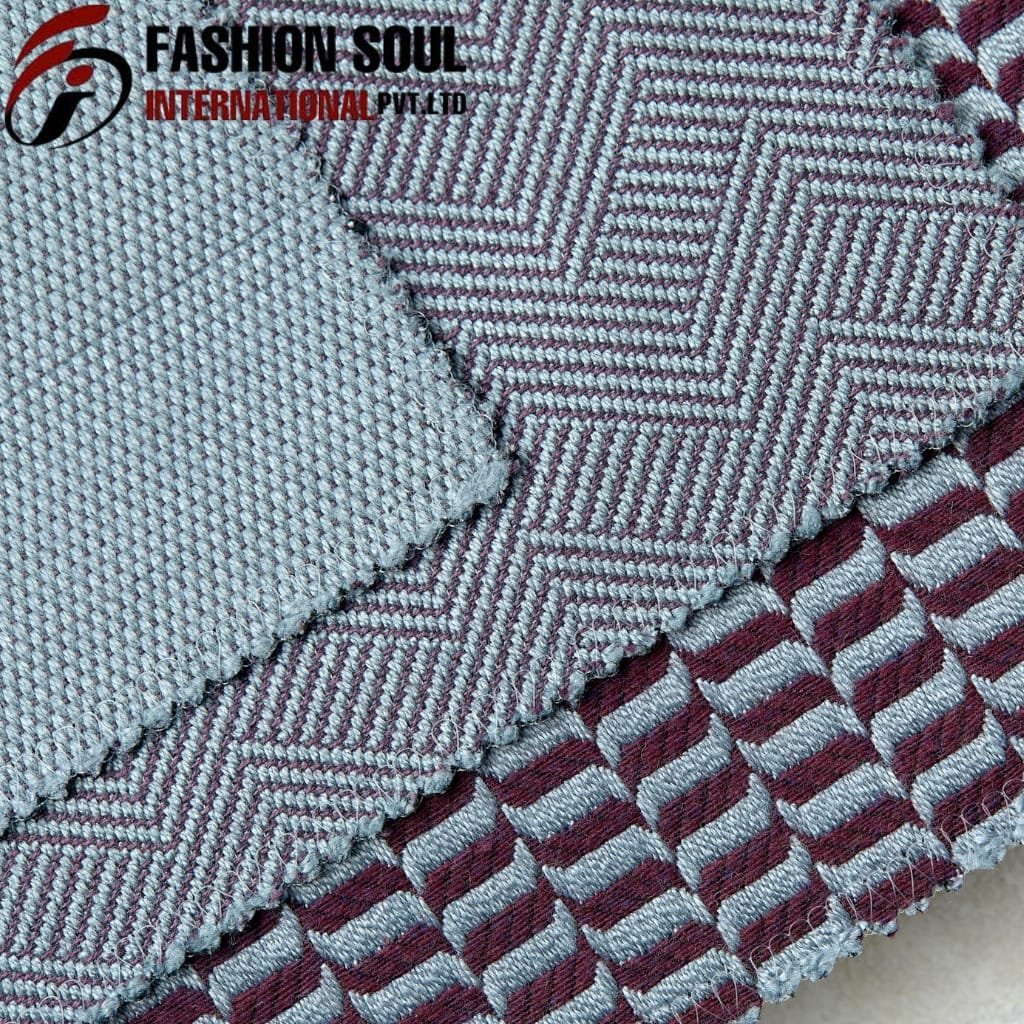 Close-up of a textured fabric sample with two different patterns; the top pattern has a geometric design with fine lines and a pinkish hue, while the bottom pattern features a repeating striped design in similar colors. The image also includes a logo in the top left corner that reads "Fashion Soul International Pvt Ltd."