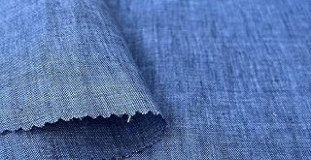 Close-up of a piece of blue chambray fabric with a folded corner