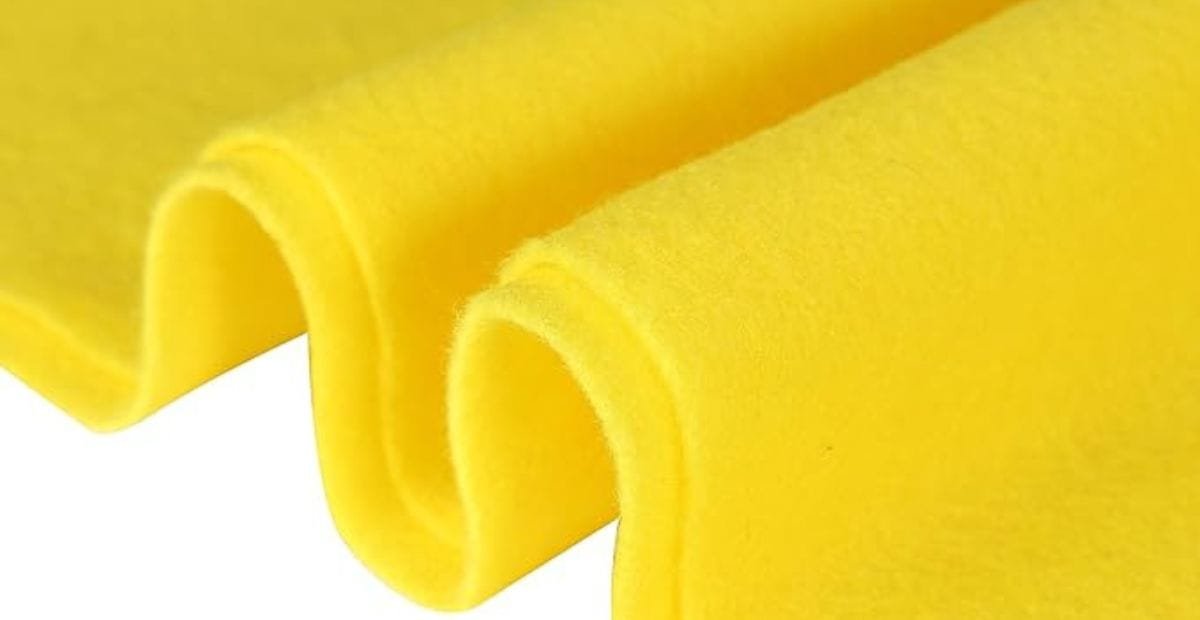 Close-up of a folded piece of bright yellow felt fabric.