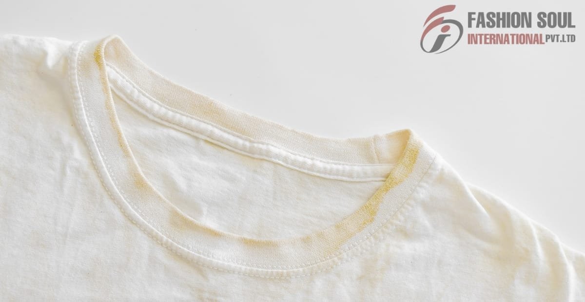 Close-up of a white cotton t-shirt collar with visible yellow sweat stains, placed on a white background.
