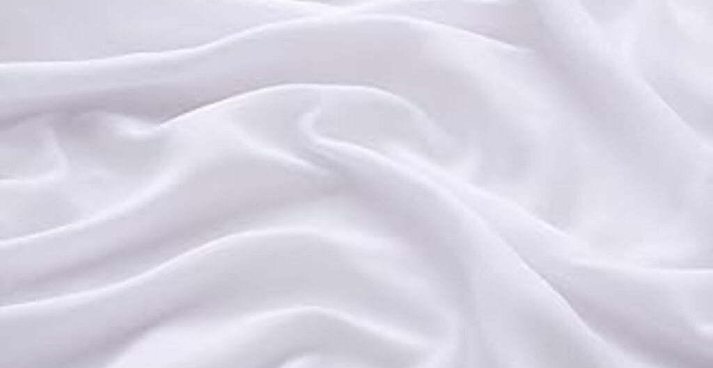 Soft white fabric with gentle folds and flowing drape.