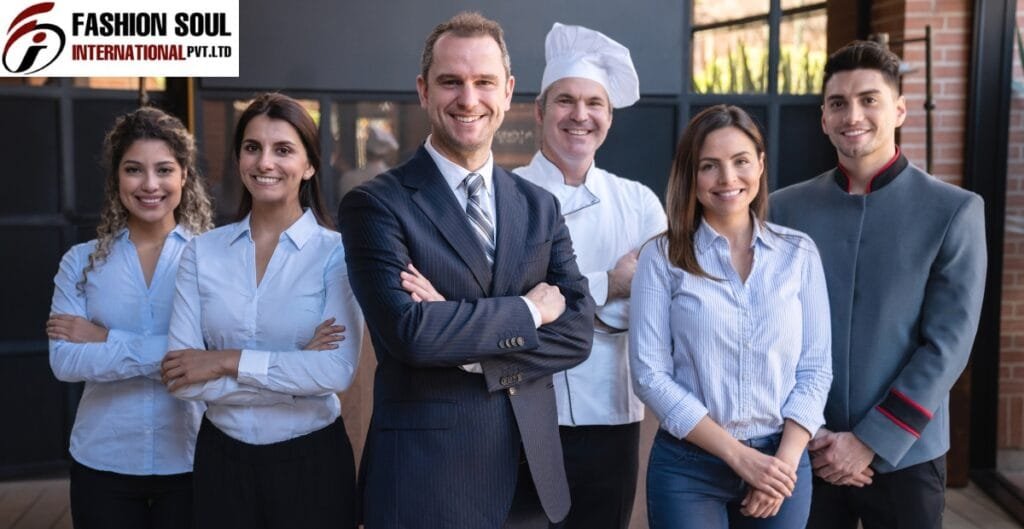 A diverse group of professionally dressed individuals, including a chef, standing outdoors in front of a modern building, smiling confidently.