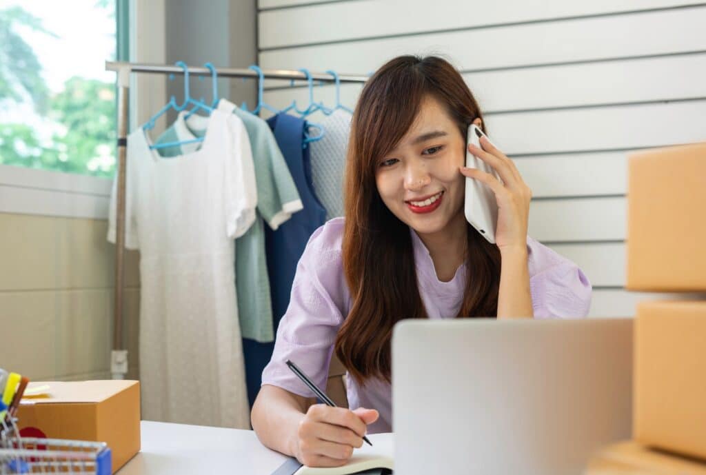 Customer service representative assisting a smiling shopper with after-sales support and reordering products.
