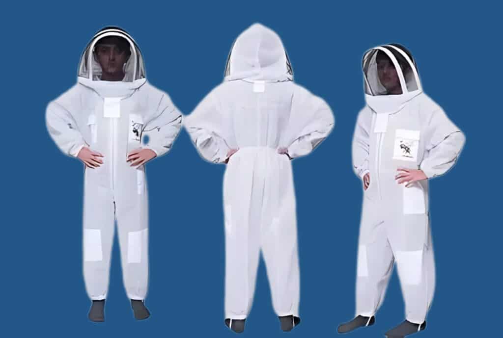 A triptych of white hazmat suits displayed from the front, back, and side on a blue background, showing protective gear with hood, face shield, and multiple patches on the legs and chest.