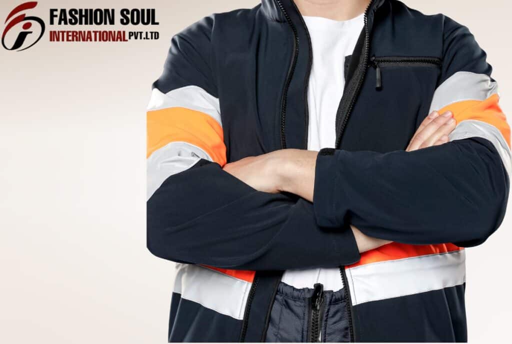 A person wearing a black, white, and orange sporty jacket with arms crossed, standing against a plain background. The logo "FASHION SOUL INTERNATIONAL PVT. LTD" is visible in the top left corner.