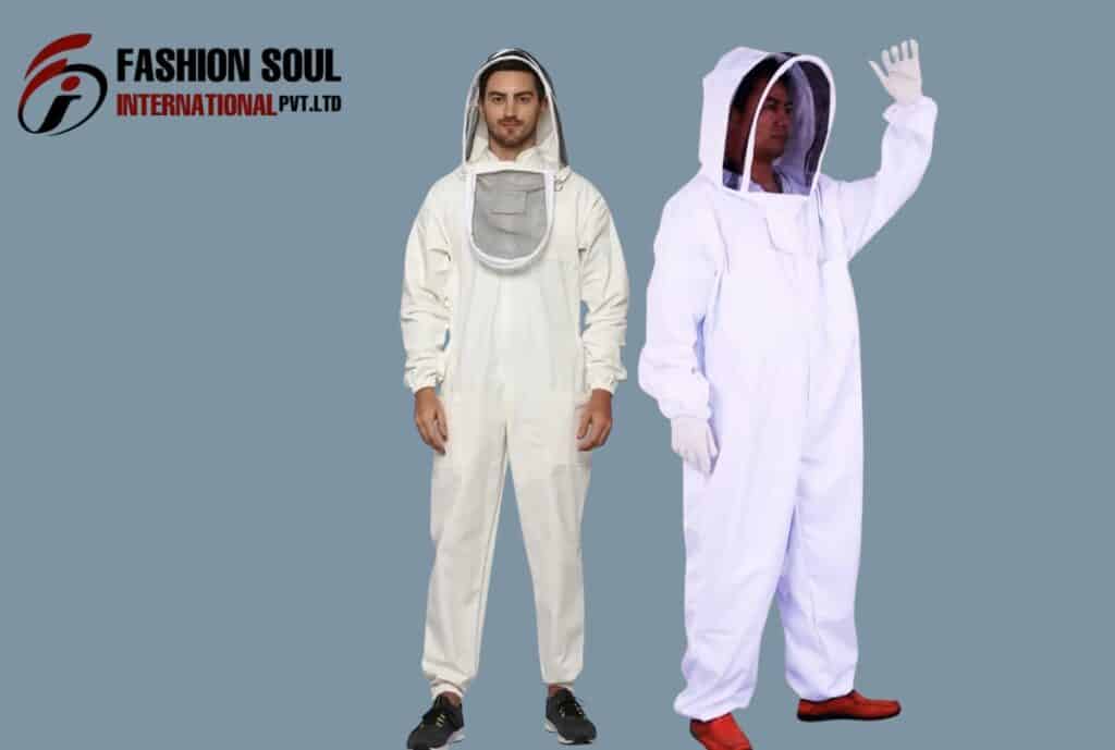 Two models wearing white beekeeping suits with veiled hoods stand against a blue-gray background. One model faces forward with hands by sides; the other models raises a hand in a waving pose. The logo “Fashion Soul International Pvt. Ltd” appears in the top-left corner.