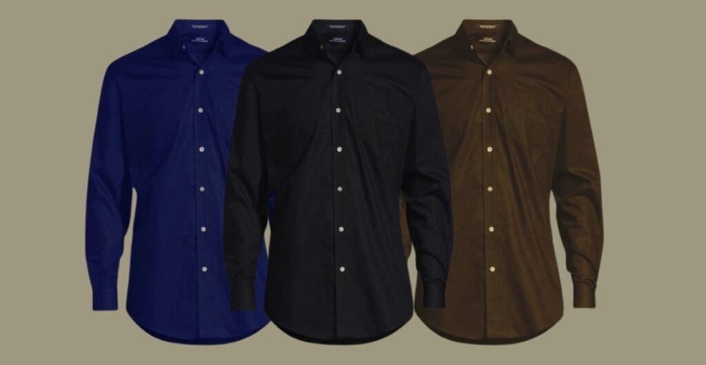 A row of premium men’s cotton work shirts in white, light blue, and navy hanging neatly on a rack, highlighting soft fabric and well-constructed stitching.