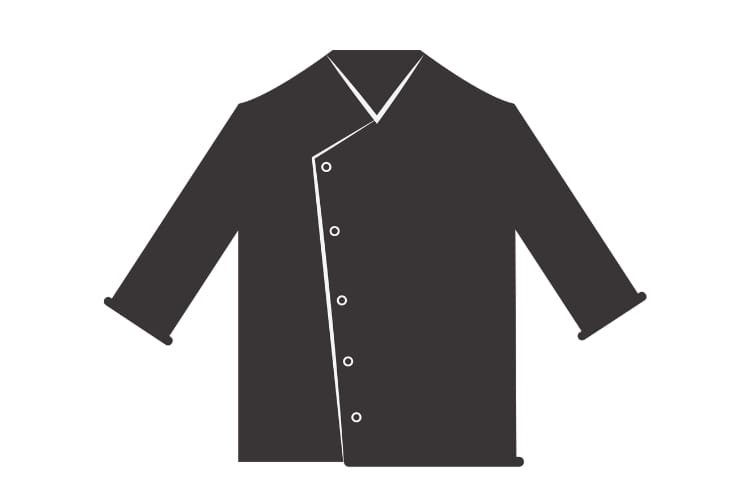 A dark-colored chef’s jacket with an asymmetrical front opening, featuring white piping along the edge and white buttons. The jacket has long sleeves, cuffs turned up, and a V-shaped collar.