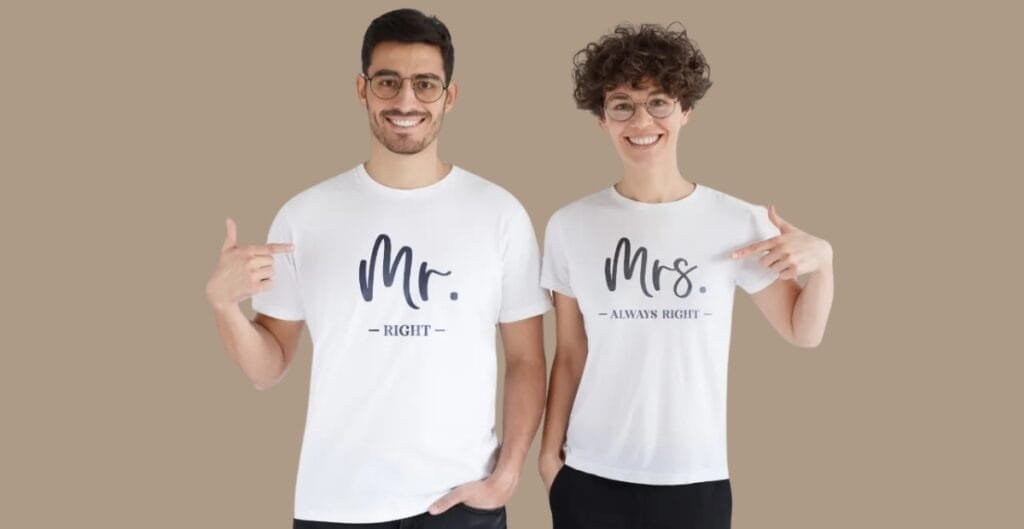 A diverse group of office staff wearing eco-friendly organization T-shirts in a bright, modern workspace. Shirts are made from sustainable materials with subtle earth-toned colors, visible recycling and organic cotton labels, and a minimalist logo. The team is collaborating at a whiteboard and sorting recyclable materials, underscoring sustainability, style, and practicality.