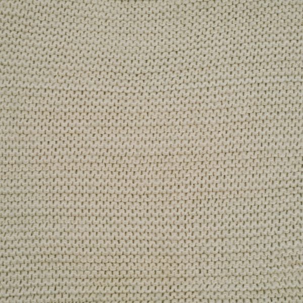  A close-up view of beige knit fabric with small interlocking loops, showing a uniform, textured surface.
