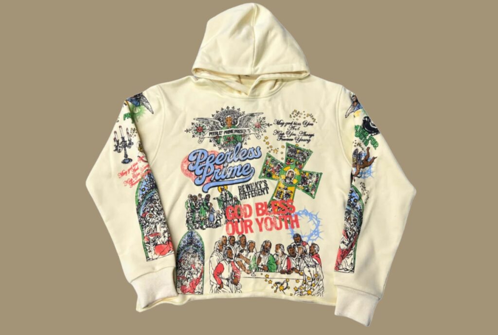 A designer reviewing fabric swatches and branding options with a luxury hoodie prototype on a worktable.