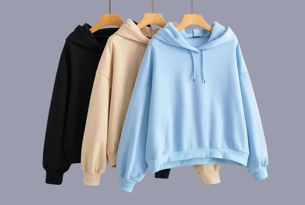 A bold, modern hoodie displayed on a mannequin in a bright showroom, with oversized silhouette and premium stitching.