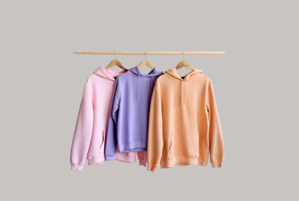 Logo and storefront of Fashion Soul International showcasing oversized hoodies on display in a German retail setting.