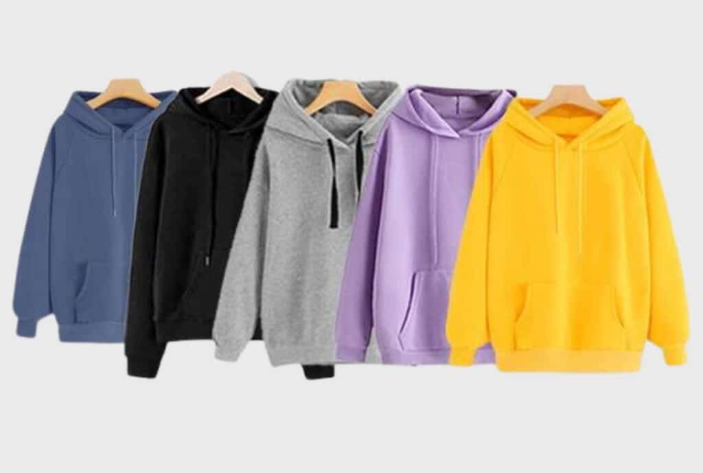 Display of oversized hoodies on hangers and in a rack, with a bold 'International' logo showcasing a leading brand in oversized hoodies.