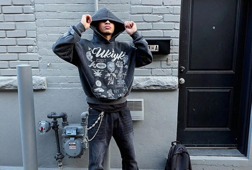 A close-up shot of a premium hoodie made from soft, plush fleece with a subtle logo embroidery, displayed on a clean, minimalist hanger.