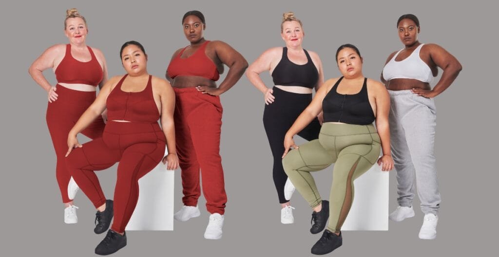 A plus-size model showcases a layered sweatpants outfit: a cozy fleece hoodie under a lightweight, oversized cardigan, paired with matching joggers in heather gray; the look emphasizes comfortable layering and flattering drape.