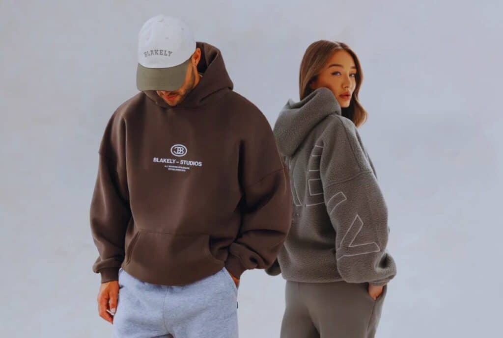 Photo of a factory floor in Spain producing oversized hoodies, with multiple sewing machines and workers assembling garments.