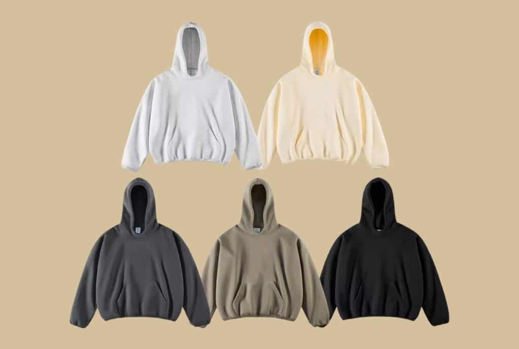 Industrial hoodie manufacturing facility in the UK with workers assembling oversized hoodies on a clean, organized line.