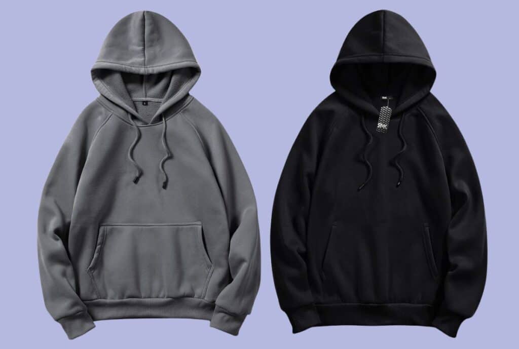 Black oversized hoodie with drop-shoulder sleeves and front kangaroo pocket, displayed on a hanger.