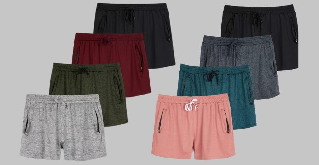Plus-size running shorts with multiple practical pockets: a zippered back pocket, a secure side pocket, and a small interior liner pocket, shown on a curved mannequin to highlight comfortable fit and stretch fabric.