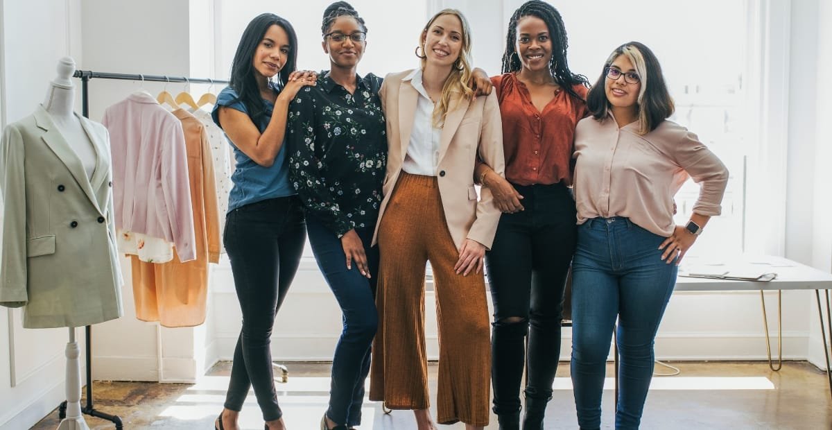 A group of women showcasing trendy clothes for short-waisted women, including high-waisted pants and tailored blazers