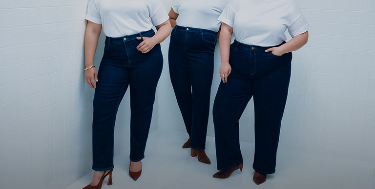 Woman confidently wearing plus-size long jeans, showing off curves