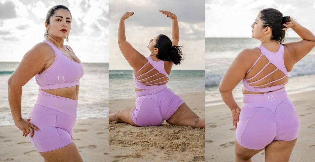 Confident woman posing on the beach in lavender plus size active shorts and matching sports bra.