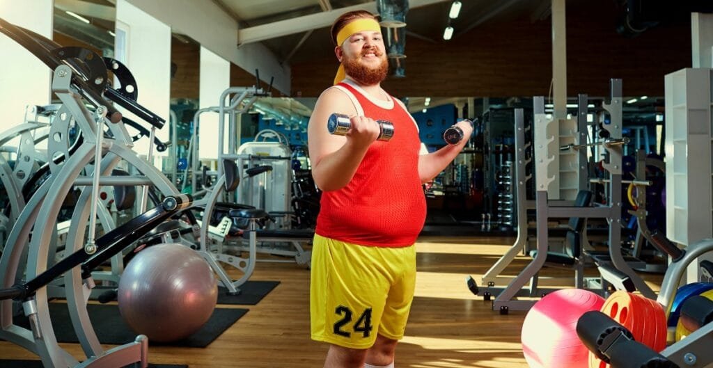 Man lifting weights in gym leggings at the fitness center